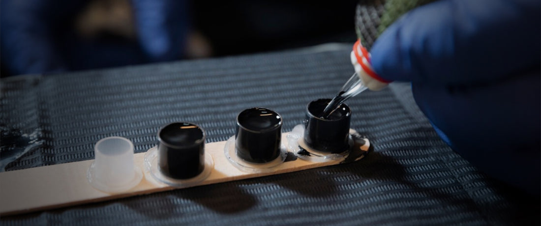 Tattoo needle being dipped into an ink pot