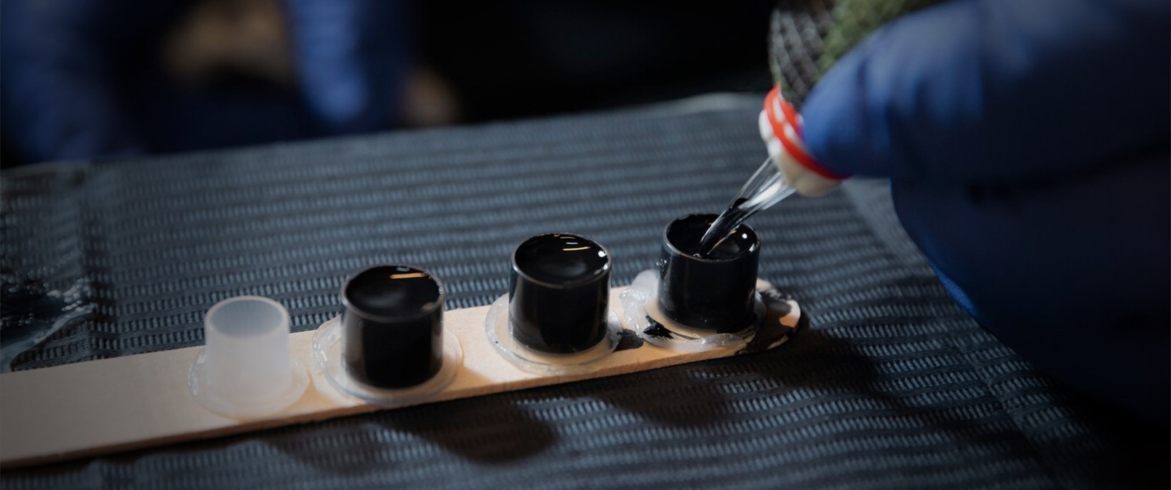 Tattoo needle being dipped into an ink pot
